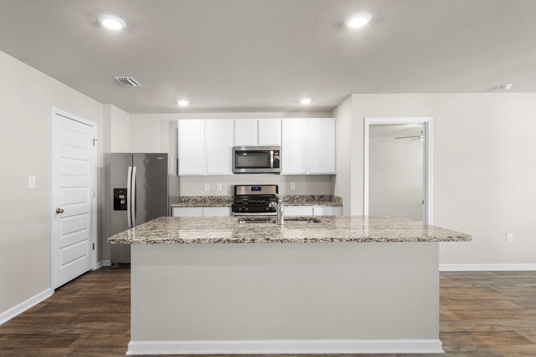 White kitchen with granite island at 24061 Citation Loop